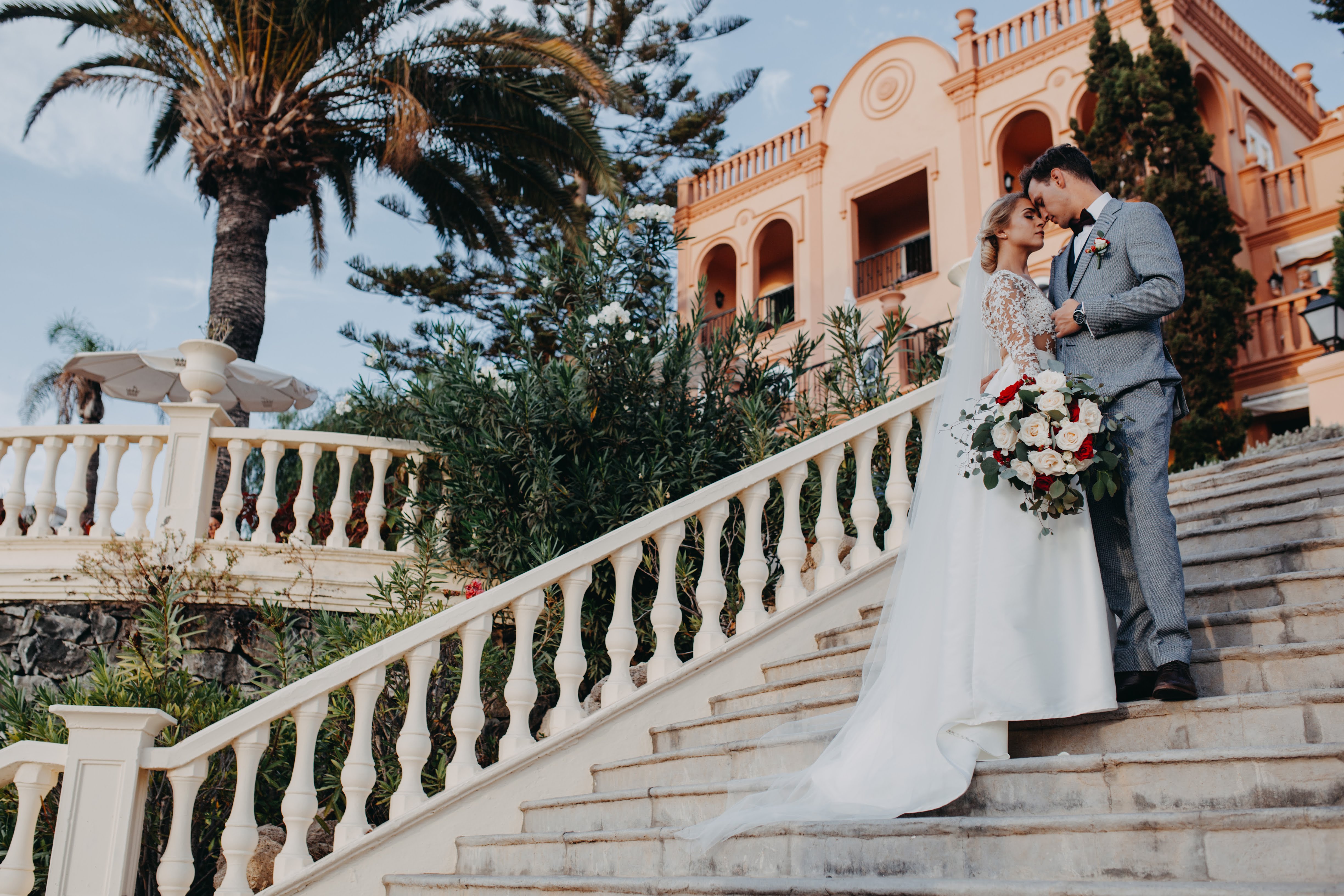 A just married couple posing on the stairs in Tenerife 